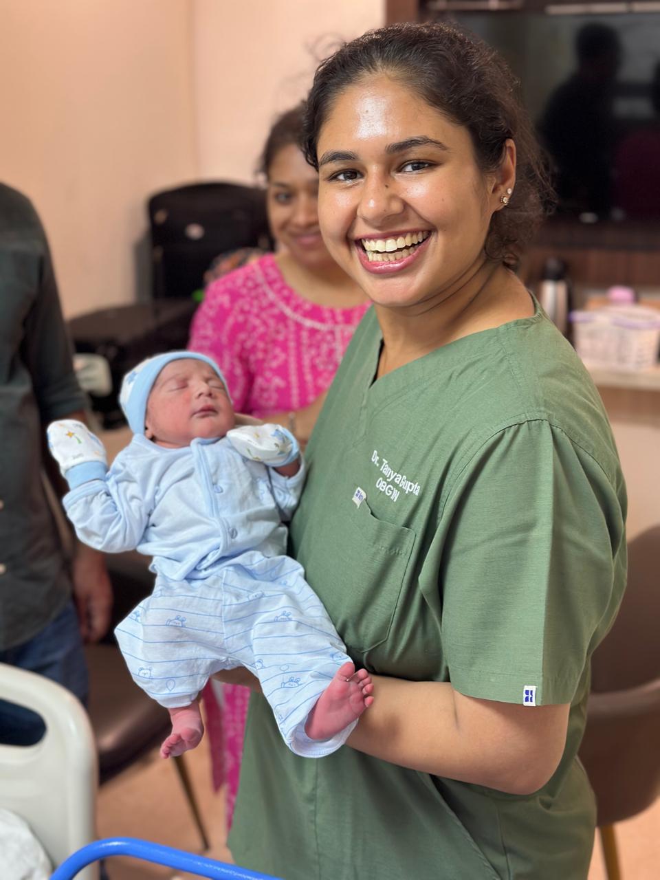 Dr. Tanya Gupta holding a newborn baby